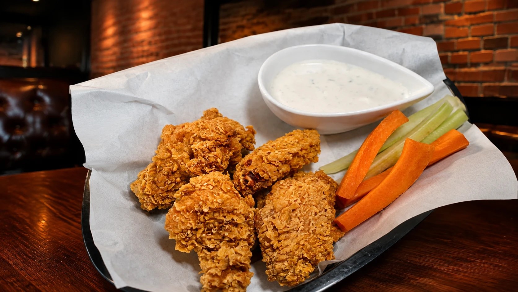 Crispy chicken wings with ranch dip, carrots and celery